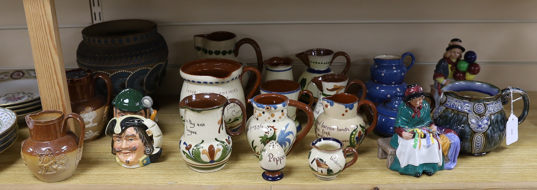 A collection of Doulton vessels and Torquay Mottoware